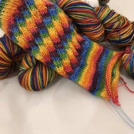 A sock in rainbow yarn.