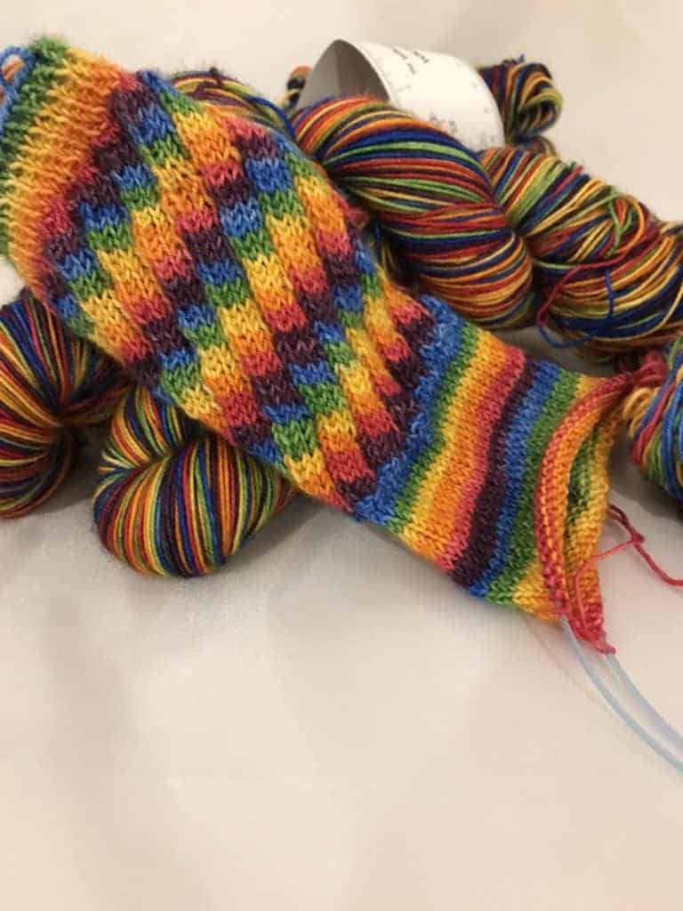 A sock in rainbow yarn.