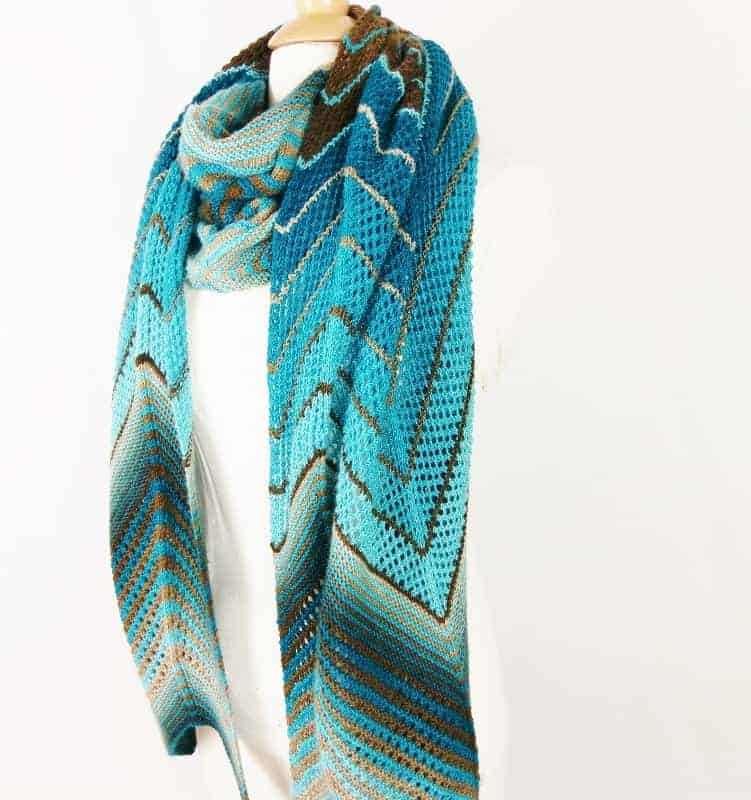 A geometric shawl in a teal to aqua gradient.