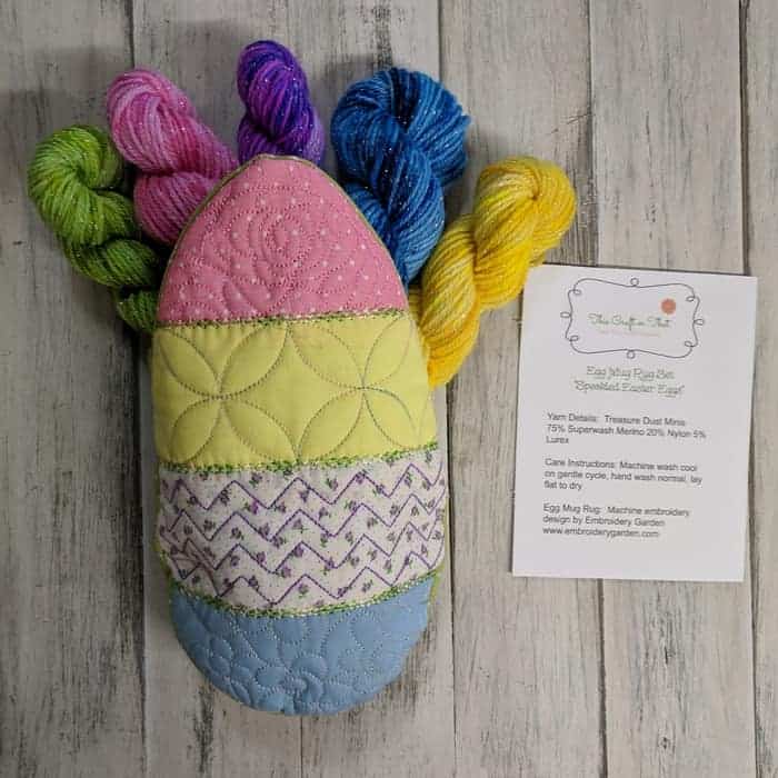 A knitted Easter egg with colorful yarn sticking out. 