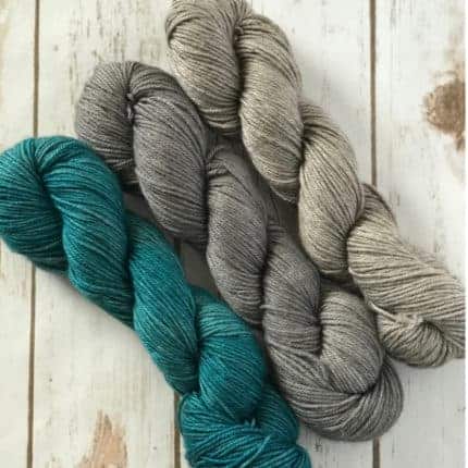 A trio of teal and gray yarn