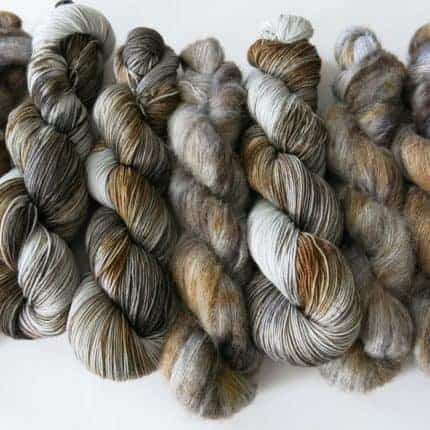 Laceweight yarn in grey and brown.