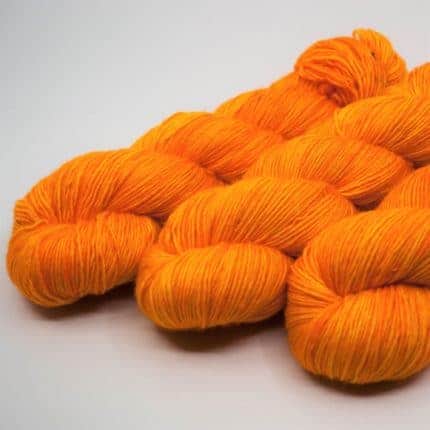 Three skeins of orange yarn