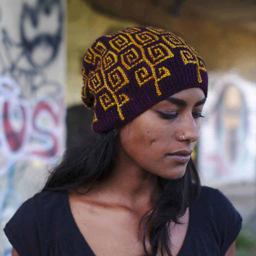 A maroon hat with a yellow geometric pattern
