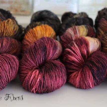 Skeins of plum and orange variegated yarn