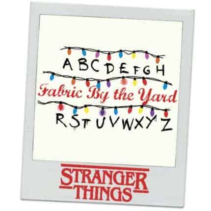 Christmas lights and the alphabet and the words Fabric by the yard and the Stranger Things logo