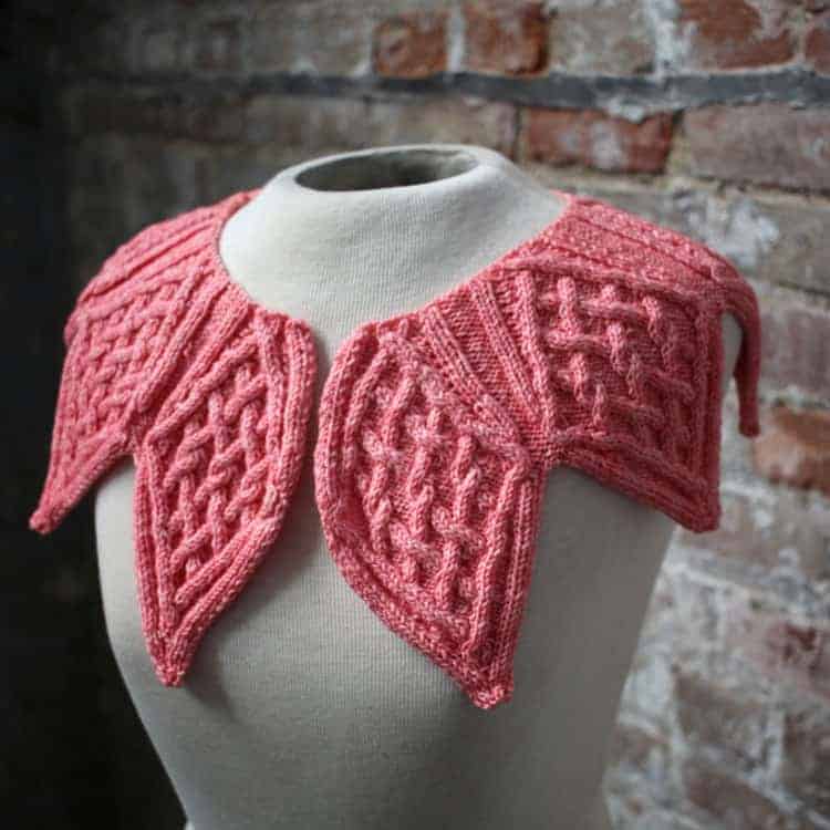 A pink scarf that looks like leaves. 