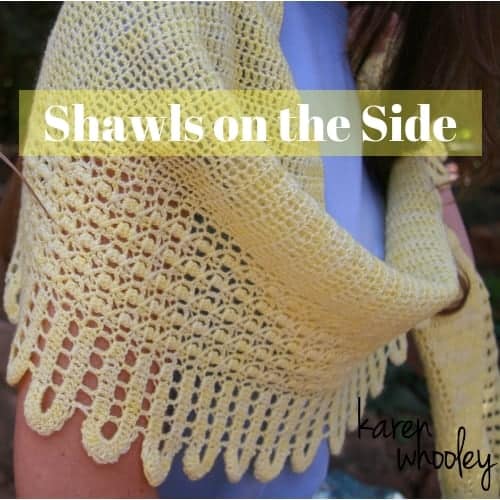 A yellow crocheted shawl with the words Shawls on the side.