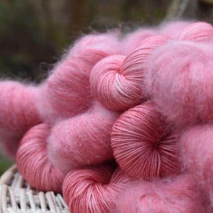 Skeins of pink wool and mohair yarn.