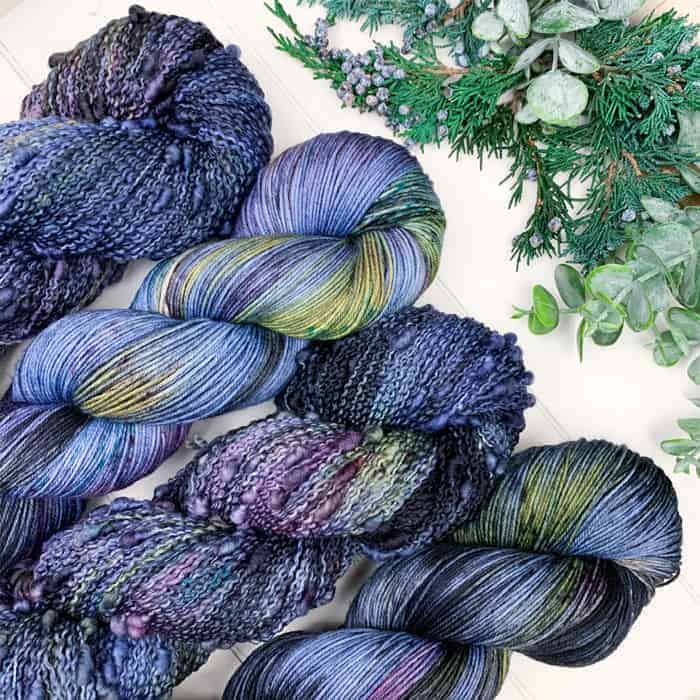 Skeins of blue, purple and yellow yarn.