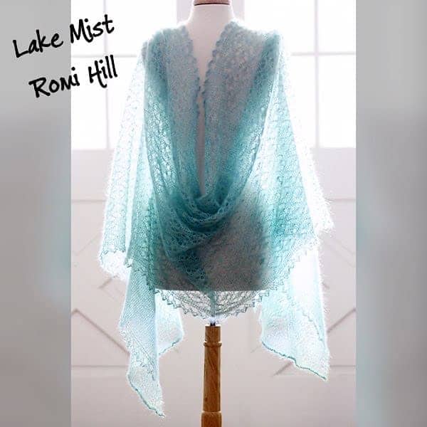 A lacy aqua shawl on a dress form.