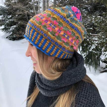 A bright colorwork hat with pink, blue and gold.