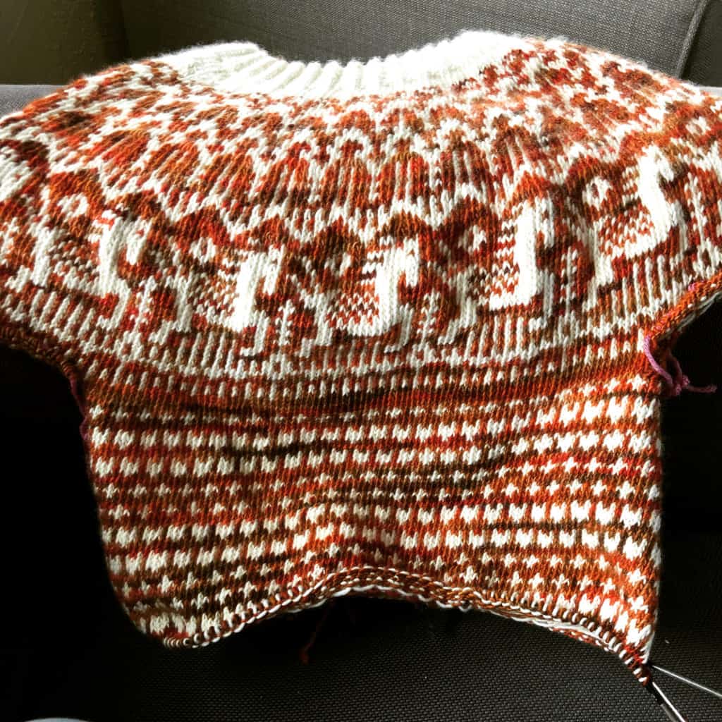 A rust and cream colorwork sweater.