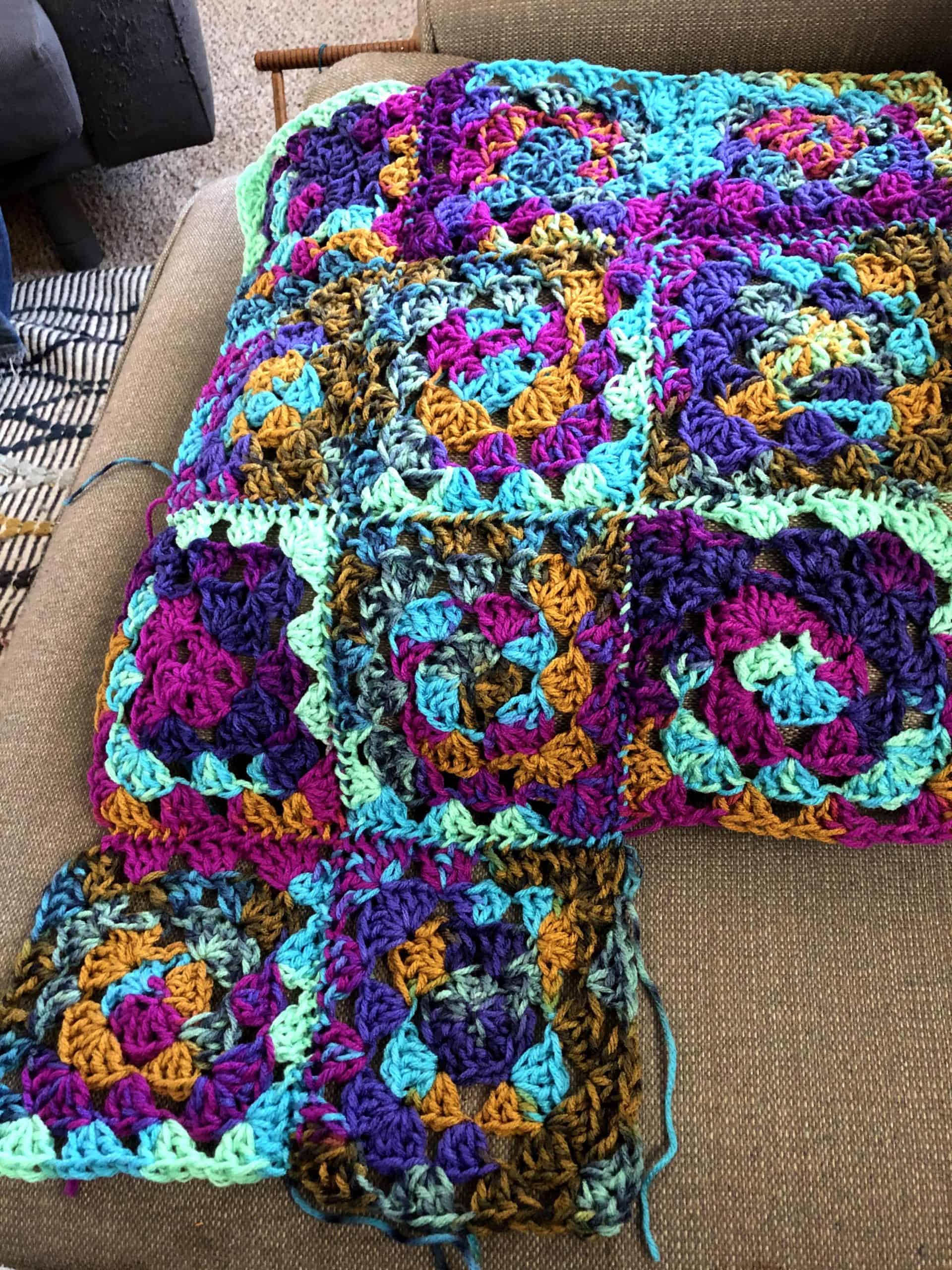 Purple, aqua and orange crocheted squares.