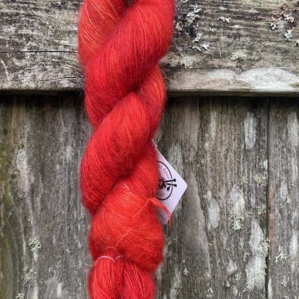A skein of red mohair yarn.