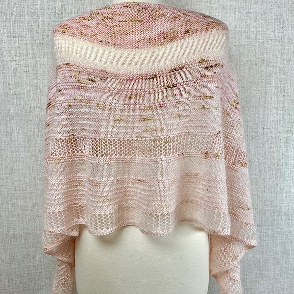 A lacy shawl in pale pink.