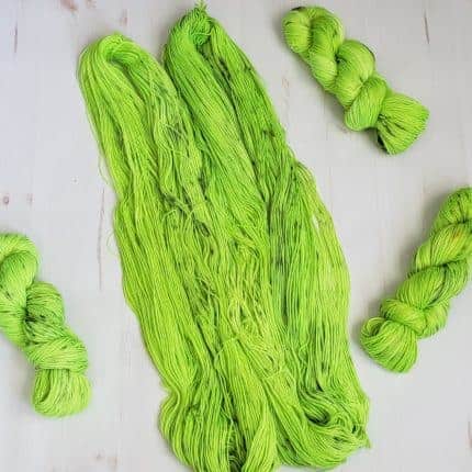 Untwisted skeins of neon green yarn.