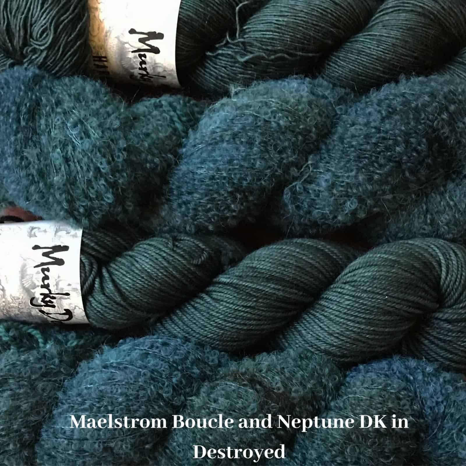 Skeins of teal Merino and boucle yarn.