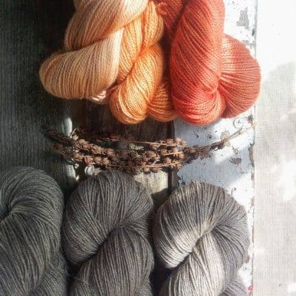 Trios of peachy orange and gray yarn.