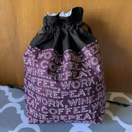 A purple and black drawstring bag.