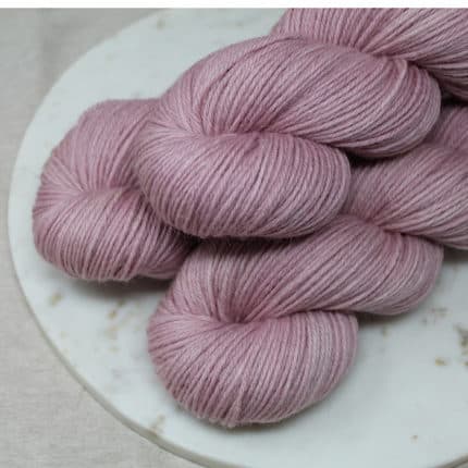 Skeins of pale pink yarn.
