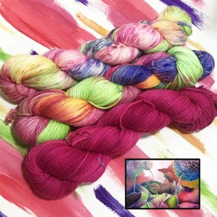 Dark pink, green, blue and orange yarn above a painting with the same hues.
