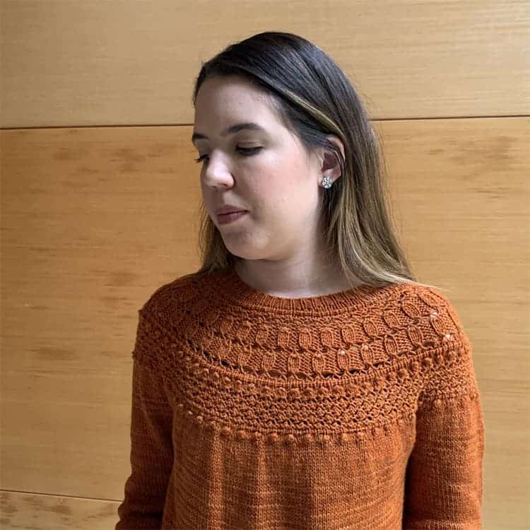 An orange-gold sweater with a lacy yoke.