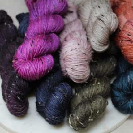 Skeins of bright colored tweed yarn.