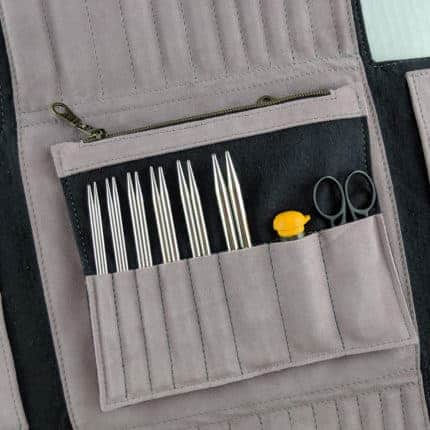 A gray and black case holding metal knitting needle tips.
