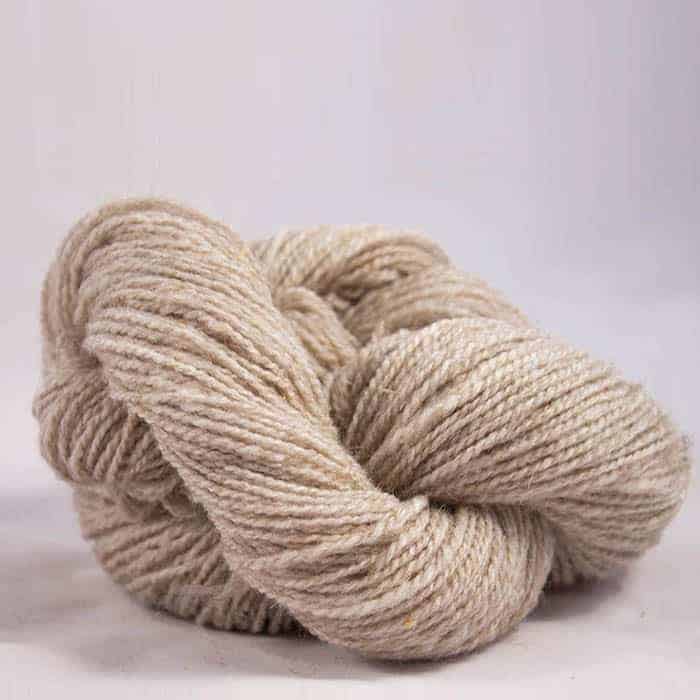 A twisted hank of rustic cream-colored yarn.