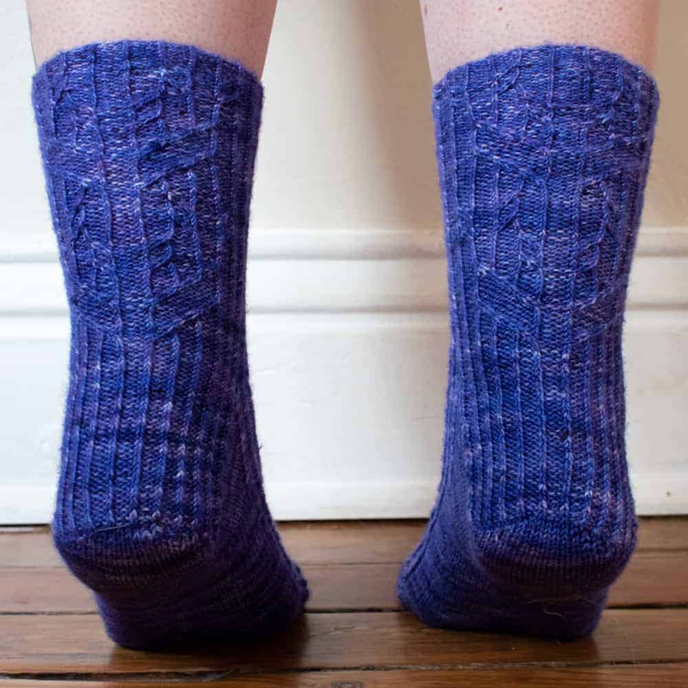 Purple cabled socks.