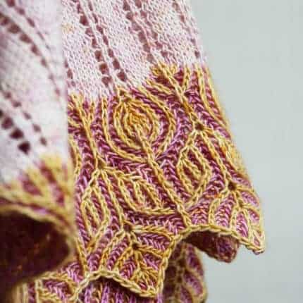 The edge of a pink and orange botanical brioche wrap.