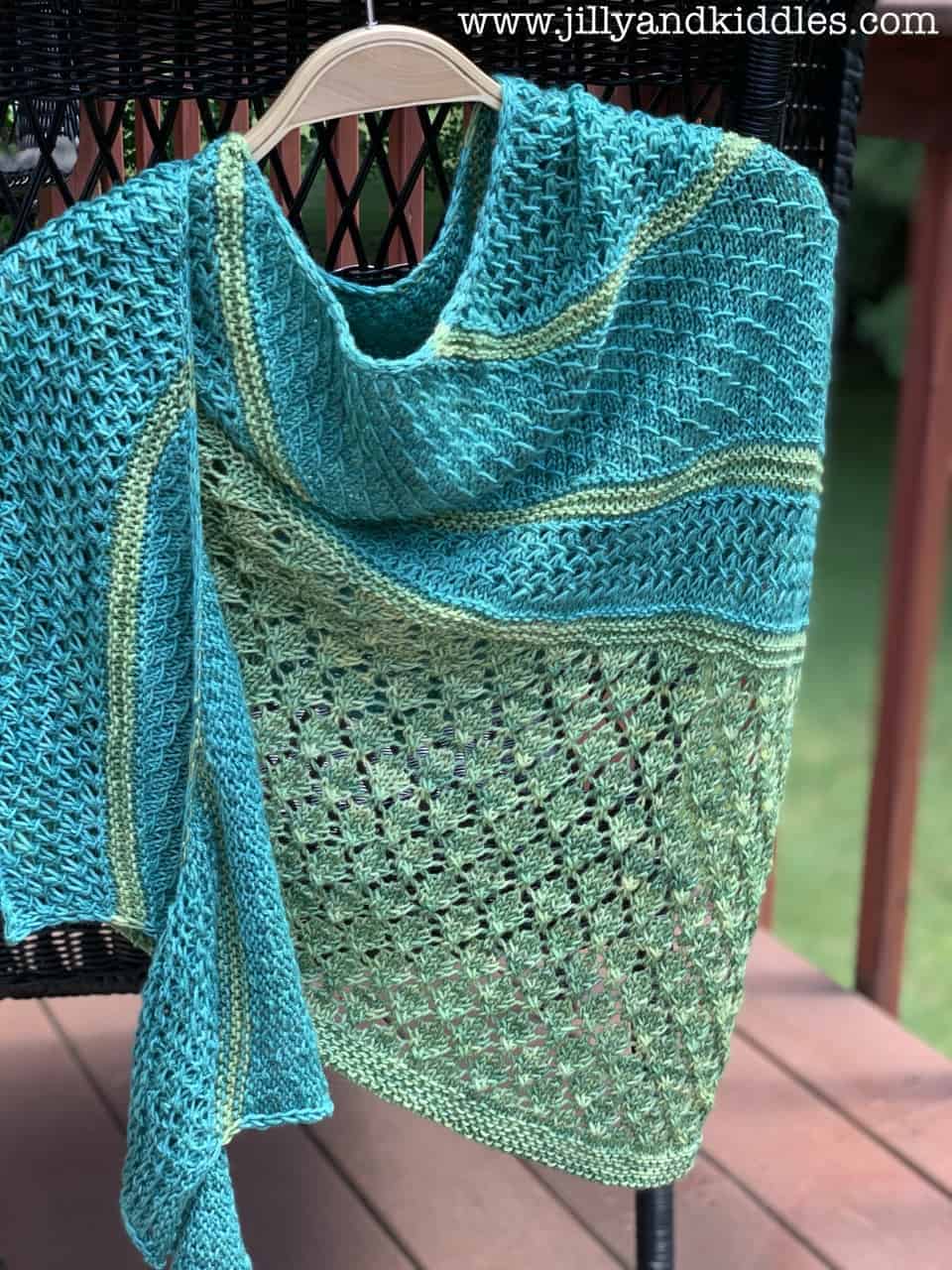 A teal and green lacy and textured shawl.