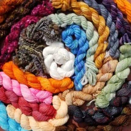 A spiral of brightly colored hanks of yarn.
