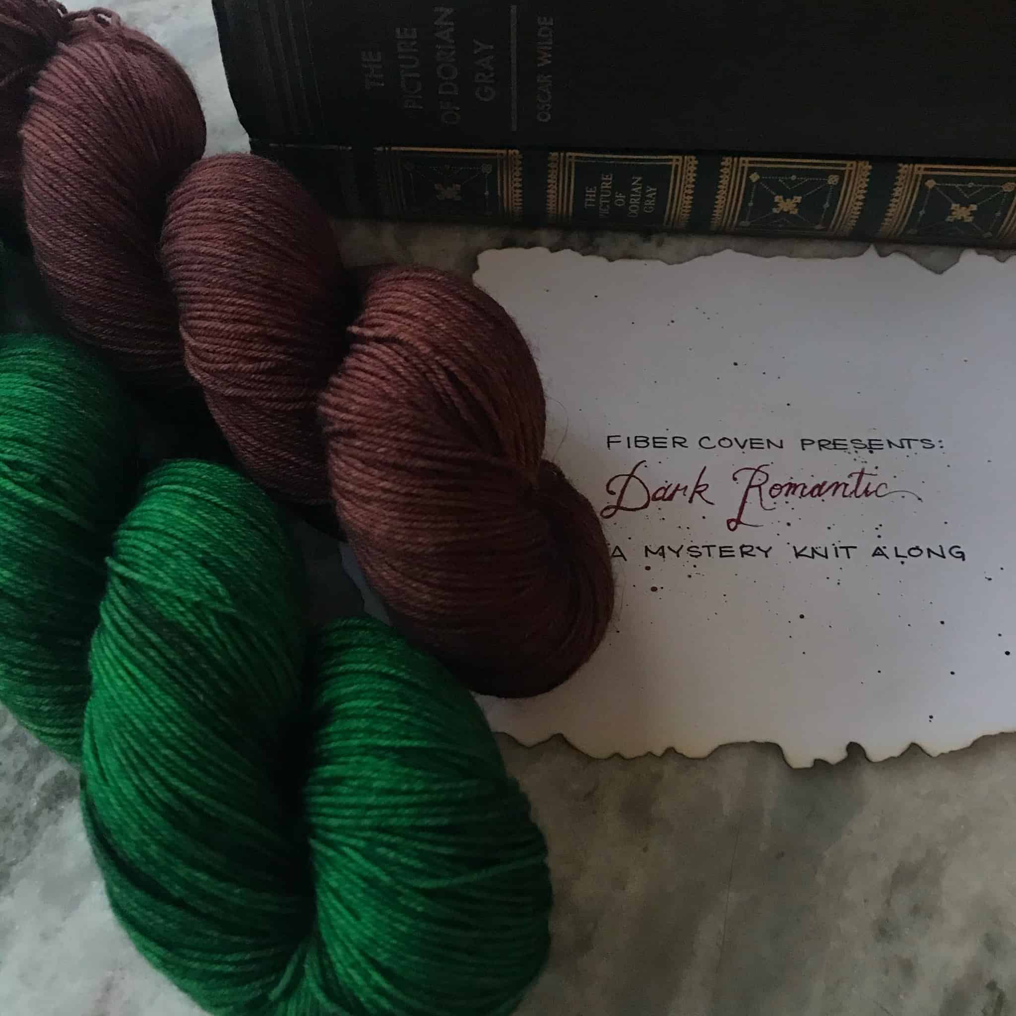Purple and green yarn next to a note with the words Dark Romantic. 