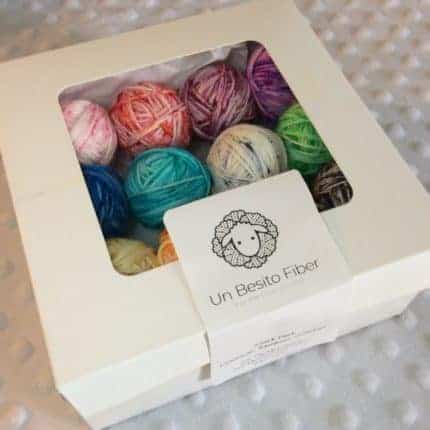 A bakery box with colorful yarn inside.