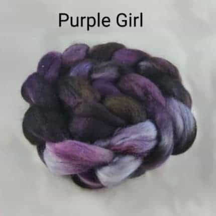 A braid of black and purple fiber and the words Purple Girl.