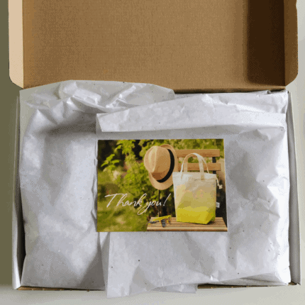 A box with a photo of a yellow tote and straw hat.