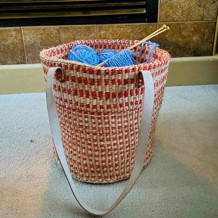 A pink basket with a strap.