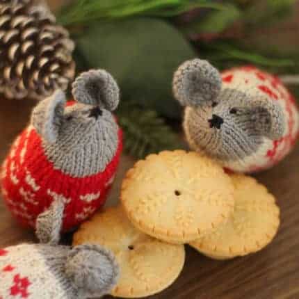 Knit gray mice in red and white sweaters.