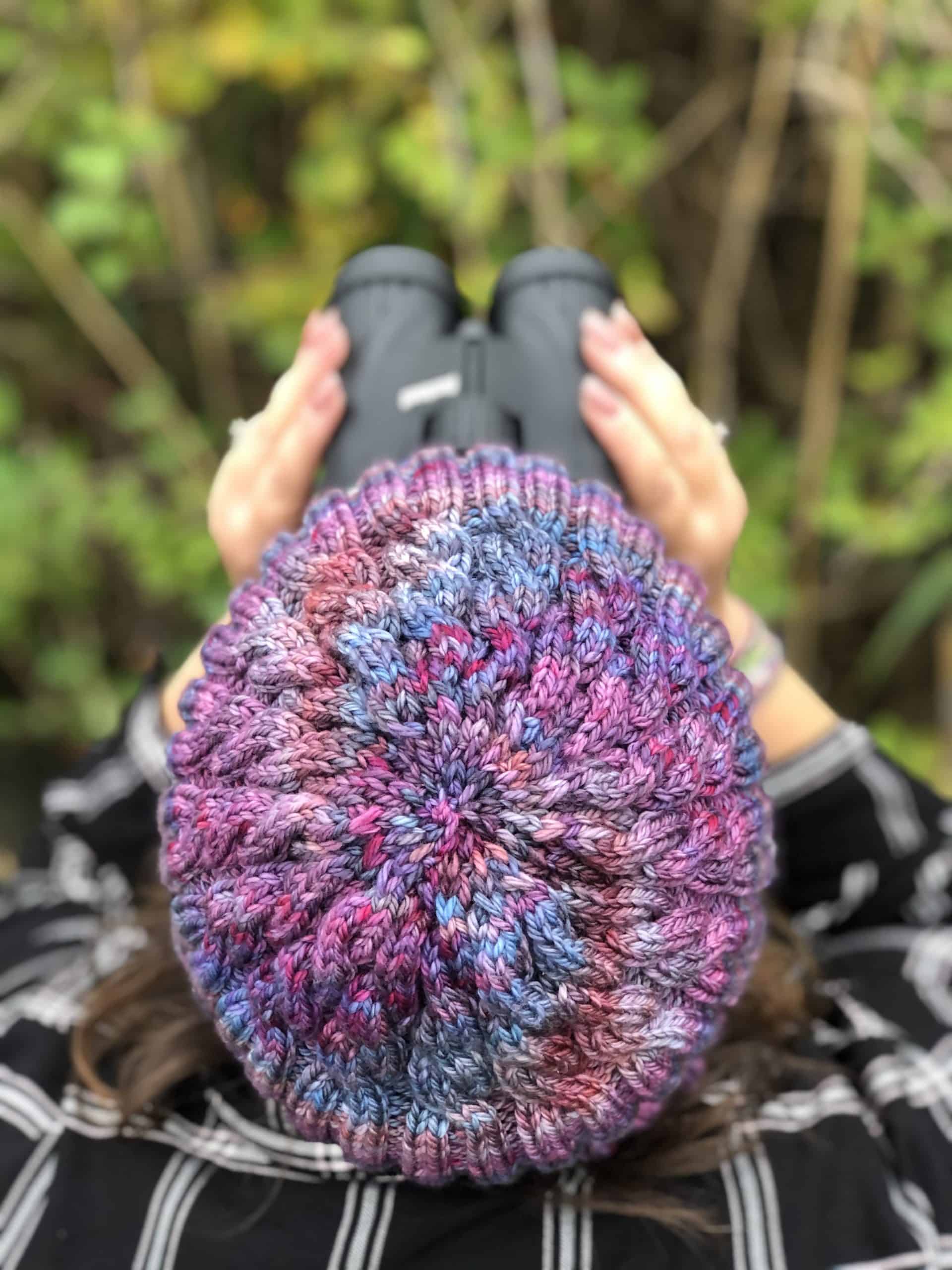 The top of a purple and blue knit hat.
