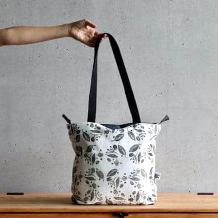 A white tote with a black floral print.