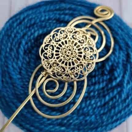 A lacy gold shawl pin.