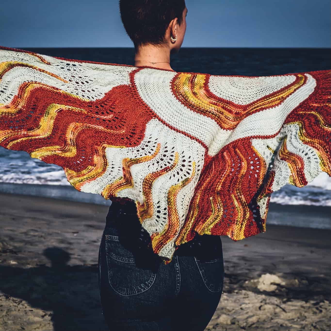 A red, yellow and white crescent shawl. 