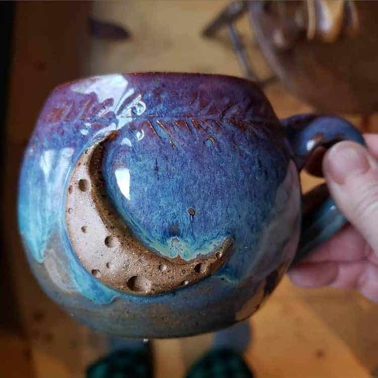 A blue and purple mug with a crescent moon.