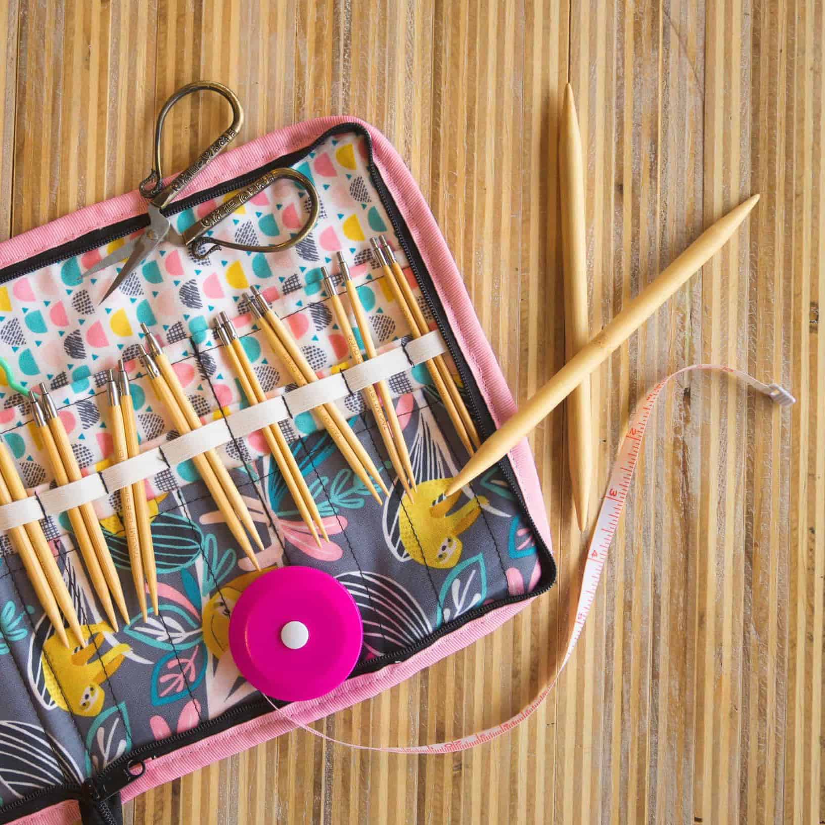 A knitting needle case filled with wooden needles.