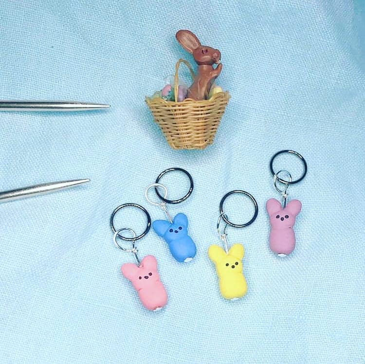 Pink, blue and yellow marshmallow Peeps charms, with a chocolate bunny in a basket.