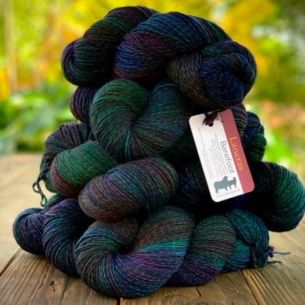 Black yarn with pops of green, blue and purple.