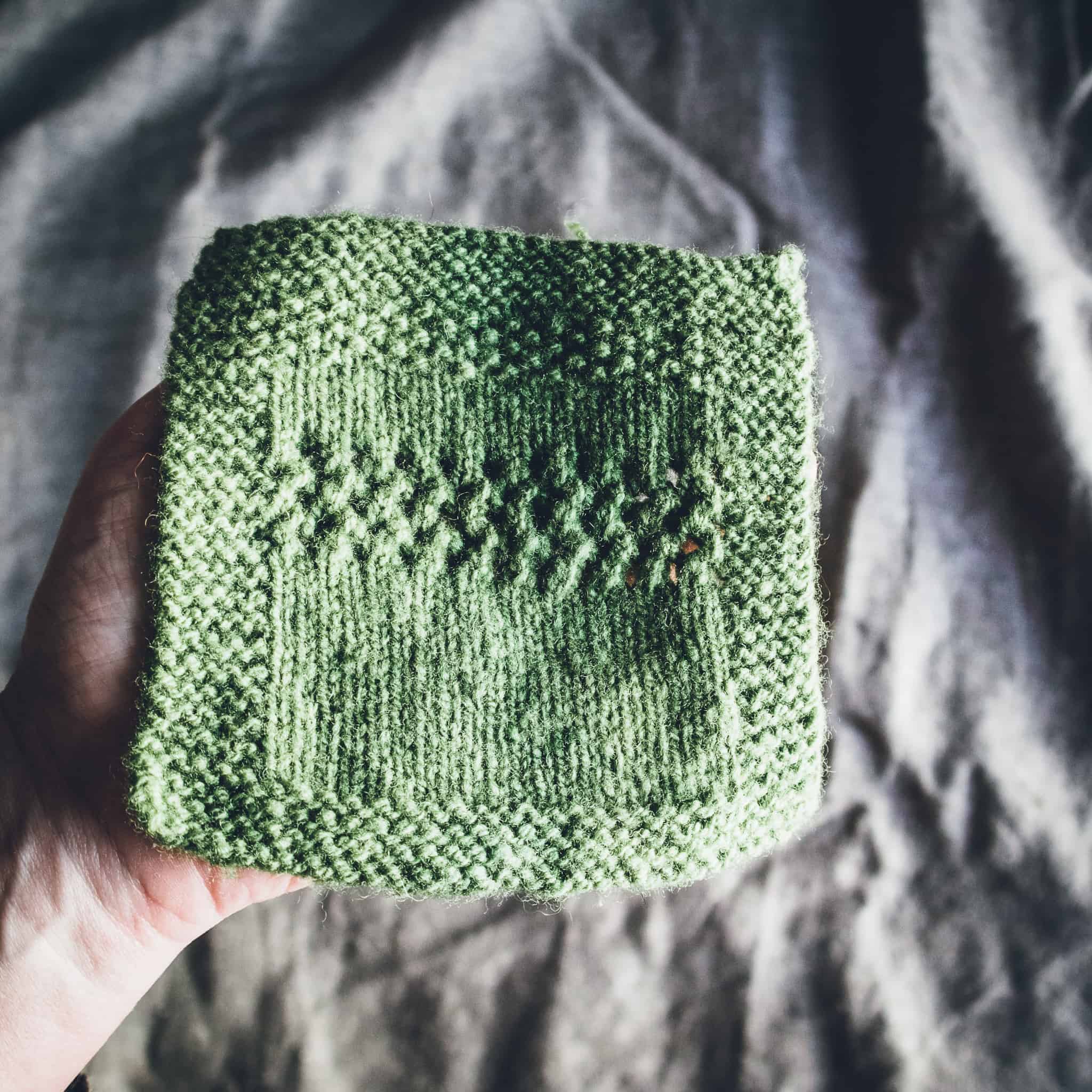 A green square of knitting.