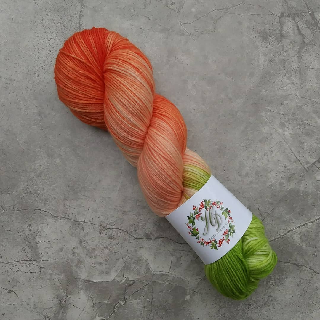 A single skein of orange and green yarn.